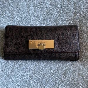 Brown Michael Kors wallet with a maroon interior